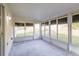 Enclosed sunroom features tile floor with access to fenced backyard at 24237 Rolling View Ct, Lutz, FL 33559
