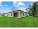 Spacious backyard featuring a covered patio and lush green lawn, perfect for outdoor enjoyment at 2919 Cascabel Ter, North Port, FL 34286