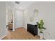 Hallway with wood-look flooring, plant, and decorative mirror at 2919 Cascabel Ter, North Port, FL 34286