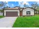 Inviting single-story home featuring a manicured lawn and a two-car garage at 2919 Cascabel Ter, North Port, FL 34286