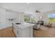 Modern kitchen with sleek countertops, stainless steel appliances, and views into the living room at 2919 Cascabel Ter, North Port, FL 34286