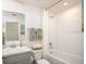 Bathroom with a shower-tub combo, vanity, and a large mirror at 16408 Courlan Rd, Weeki Wachee, FL 34614