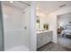 Bright bathroom featuring a walk-in shower, a vanity, and an open doorway at 16408 Courlan Rd, Weeki Wachee, FL 34614