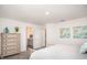 Bright bedroom featuring a cozy bed, dresser, and adjoining bathroom at 16408 Courlan Rd, Weeki Wachee, FL 34614