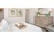 Bright bedroom features stylish decor, a comfortable bed, and a charming dresser set at 16408 Courlan Rd, Weeki Wachee, FL 34614