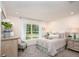 Bedroom with a large window, a comfortable bed, and stylish decor at 16408 Courlan Rd, Weeki Wachee, FL 34614