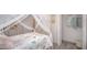 Charming bedroom featuring a canopy bed and ample storage with closet at 16408 Courlan Rd, Weeki Wachee, FL 34614