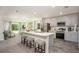 Bright kitchen featuring a center island, sleek appliances, and stylish countertops with an adjacent living area at 16408 Courlan Rd, Weeki Wachee, FL 34614