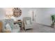 Cozy living room featuring stylish seating, modern decor, and a decorative clock at 16408 Courlan Rd, Weeki Wachee, FL 34614