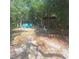 Spacious backyard featuring comfortable blue Adirondack chairs perfect for relaxing at 5148 Cyril Dr, Dade City, FL 33523