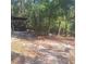 Backyard barbecue area with a black grill in a wooded area at 5148 Cyril Dr, Dade City, FL 33523