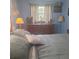 Comfortable bedroom bathed in natural light, showcasing wooden furniture and tasteful decorations at 5148 Cyril Dr, Dade City, FL 33523