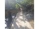 Wooden dock extending towards the water, surrounded by trees at 5148 Cyril Dr, Dade City, FL 33523
