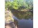A wooden dock with newly installed planks extending into the water, surrounded by natural scenery at 5148 Cyril Dr, Dade City, FL 33523