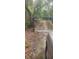 Gated driveway surrounded by trees leading to a wooded area, offering privacy at 5148 Cyril Dr, Dade City, FL 33523