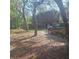 Charming house exterior with lush greenery, a vehicle, and a picnic table at 5148 Cyril Dr, Dade City, FL 33523