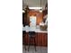 Kitchen with bar seating, vintage appliances, and wood paneling blends convenience with vintage at 5148 Cyril Dr, Dade City, FL 33523
