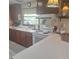 Functional kitchen features wood cabinets, white appliances, and plenty of countertop space for meal preparation at 5148 Cyril Dr, Dade City, FL 33523