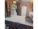 Cozy kitchen with white appliances, bar seating, and vintage-style décor at 5148 Cyril Dr, Dade City, FL 33523
