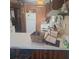 Rustic kitchen with white appliances, wood cabinets, and bar seating for a cozy and functional cooking space at 5148 Cyril Dr, Dade City, FL 33523