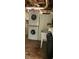 Laundry area featuring a washer, dryer, sink and storage cabinets at 5148 Cyril Dr, Dade City, FL 33523