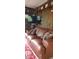 Comfortable living room with a large leather sofa and mounted television at 5148 Cyril Dr, Dade City, FL 33523