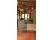 Rustic porch featuring exposed wood beams and ample natural light, perfect for enjoying the outdoors at 5148 Cyril Dr, Dade City, FL 33523