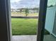 View of the spacious backyard and fence from the patio through the sliding glass door at 7677 Deer Valley Circle, Tampa, FL 33635
