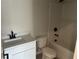 Well-lit bathroom with a shower-tub combination and a white vanity with black hardware at 7677 Deer Valley Circle, Tampa, FL 33635