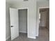 This bedroom offers neutral carpeting and paint, with walk-in closet and access to a hallway at 7677 Deer Valley Circle, Tampa, FL 33635