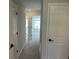 Well-lit hallway with carpet and white doors, creating an inviting transition between rooms at 7677 Deer Valley Circle, Tampa, FL 33635