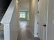 Inviting hallway featuring wood-look tile flooring and natural light, perfect for a welcoming home at 7677 Deer Valley Circle, Tampa, FL 33635