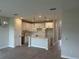 Bright, white kitchen featuring a center island, modern lighting and tile flooring at 7677 Deer Valley Circle, Tampa, FL 33635