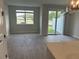 An open living space features tile floors, a sliding glass door and abundant light at 7677 Deer Valley Circle, Tampa, FL 33635