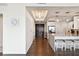 Open kitchen view showing the island with bar seating, entry doors and hardwood floors at 1209 E Cumberland Ave # 2101, Tampa, FL 33602
