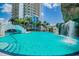 Resort-style pool area with waterfalls, palm trees, and a surrounding sun deck at 1209 E Cumberland Ave # 2101, Tampa, FL 33602