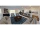 Open-concept living room featuring neutral walls, hardwood floors and abundant natural light from sliding doors at 14684 Italy Ave, Dade City, FL 33523