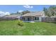 Well-maintained backyard featuring green grass, a screened lanai, and a wood fence for added privacy at 205 Island Water Way, Apollo Beach, FL 33572