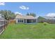 Lush, fenced backyard with a screened-in porch, perfect for enjoying outdoor living at 205 Island Water Way, Apollo Beach, FL 33572