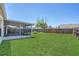 Private backyard area featuring a screened-in lanai and a spacious lawn at 205 Island Water Way, Apollo Beach, FL 33572