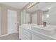 Bathroom featuring dual sinks, vanity, and a glass-enclosed shower at 205 Island Water Way, Apollo Beach, FL 33572