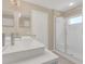 Modern bathroom with dual sinks, a white vanity, and a glass-enclosed shower at 205 Island Water Way, Apollo Beach, FL 33572