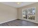 This bedroom features a ceiling fan, wood floors, and a window offering natural light at 205 Island Water Way, Apollo Beach, FL 33572