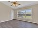 Bright bedroom with wood floors, a ceiling fan, and a window with a view of the backyard at 205 Island Water Way, Apollo Beach, FL 33572