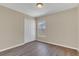 Simple bedroom with wood floors, closet, and a window allowing natural light at 205 Island Water Way, Apollo Beach, FL 33572