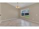 The dining space features tile floors, neutral walls, and a large window with backyard views at 205 Island Water Way, Apollo Beach, FL 33572