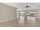 Spacious living room boasts neutral walls, tile flooring, and sliding doors to the outdoor patio at 205 Island Water Way, Apollo Beach, FL 33572