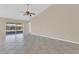 Open living space showcases tile flooring, neutral walls, and glass sliding door accessing the patio at 205 Island Water Way, Apollo Beach, FL 33572