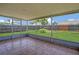 Screened patio with tile floors and a view of the fenced backyard at 205 Island Water Way, Apollo Beach, FL 33572