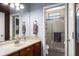 Bathroom featuring double vanity and glass-enclosed shower with stone accents at 36846 Perry Ct, Dade City, FL 33525